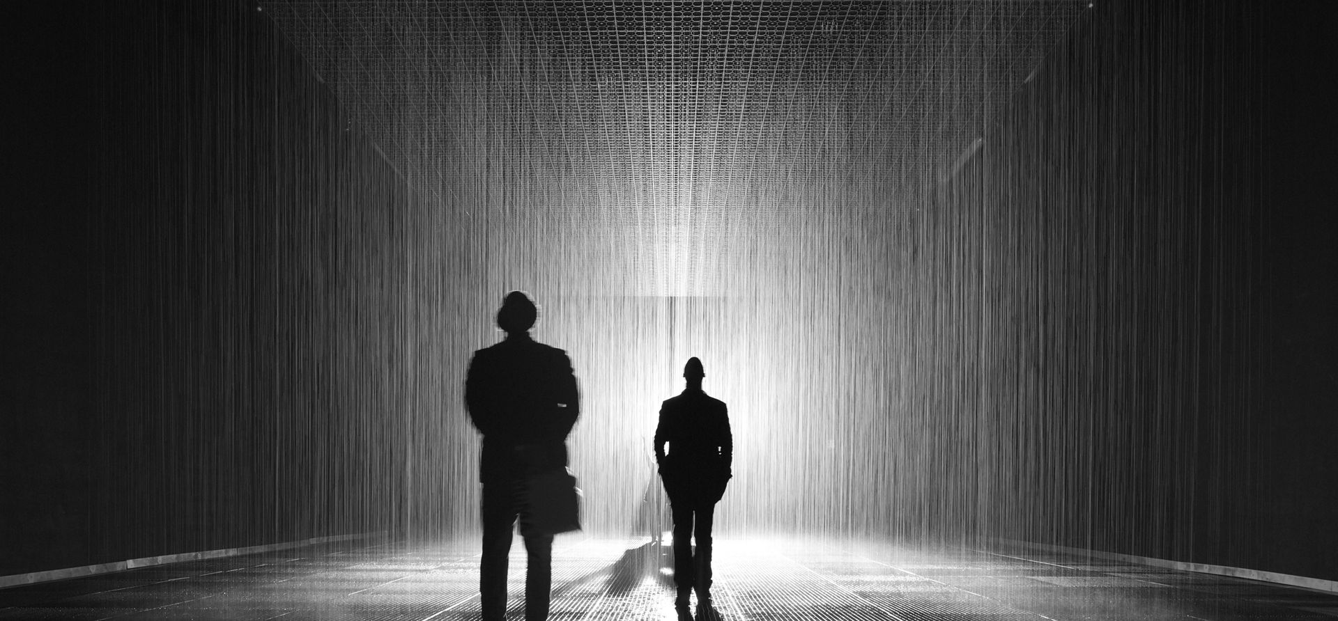 A Man That Is Standing In A Rain Room