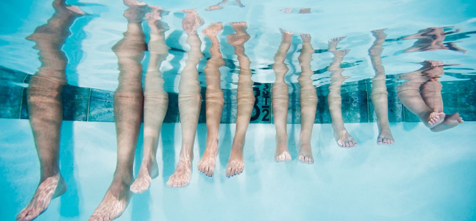 A Group Of People Swimming In A Pool