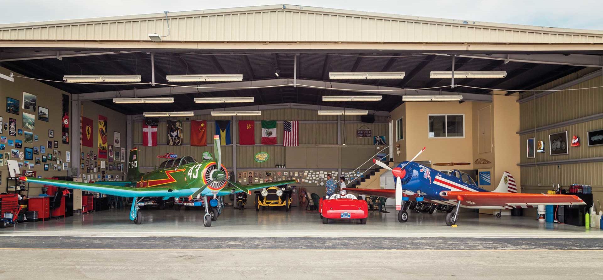 Airplanes and Vintage Cars in a Hangar